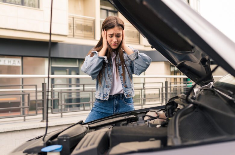 Young worried girl of the mechanic the problem with a car Young worried girl of the mechanic the problem with a car